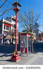 Victoria, BC, Canada - April 14 2021 : Chinese style telephone booth and street light in Victoria Chinatown.