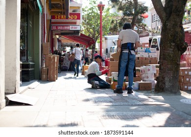 Victoria, BC, Canada - July 31, 2018: Worker Takes Inventory Of Food In Victoria's Chinatown