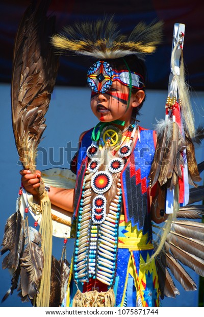 VICTORIA BC CANADA JUNE 24 2015: Unidentified Native\
Indian boy in traditional costume. First Nations in BC constitute a\
large number of First Nations governments and peoples in the\
province of BC