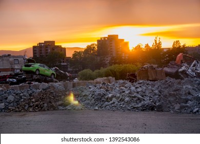 Victoria, British Columbia, Canada  06-67-2016. The setting sun illuminates the discarded trash, cars and junk of a dystopian urban society.