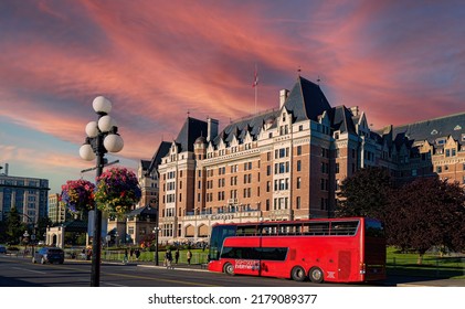 Victoria British Columbia -Canada- 7-14-2022:  A Red Tour Bus Parked In Front Of A Large Hotel Along The Harbor In Downtown Victoria, British  Columbia, Canada