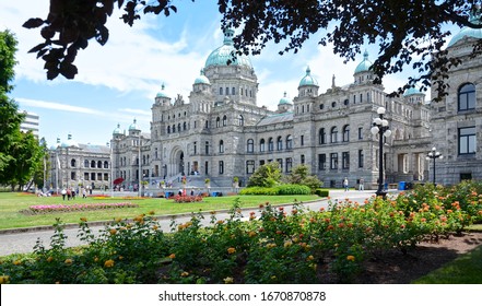 Victoria, British Columbia, Canada - June 17, 2018: Amazing architecture of a historic neo-baroque British Columbia Parliament building and beautiful public park on a bright sunny day