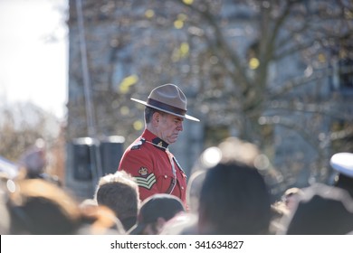 Victoria, British Columbia/ Canada-November 11: Remembrance Day Ceremony, Victoria Cenotaph On November 11, 2015. Royal Canadian Mounted Police Standing Guard At The Cenotaph In A Crowd Of People