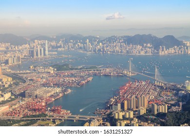 Victoria Harbour, Hong Kong, camera facing southeast, with container terminals at left and right bottom corners. HK island in distance. Note Stonecutters Bridge near right