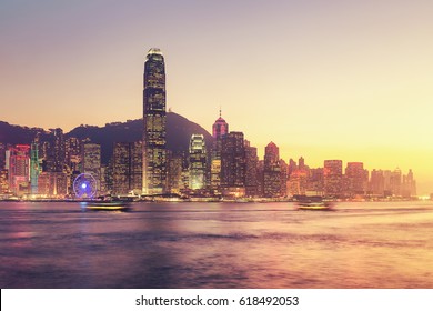 Victoria Harbour In Hong Kong Island In China. Landscape City And View Of High Building, Port And Skyline At Twilight. The Harbour Is Tourist Attraction Of Hong Kong. Center Of Business And Travel.