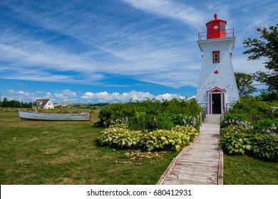Victoria Lighthouse With Dinghy On Prince Edward Island, Canada