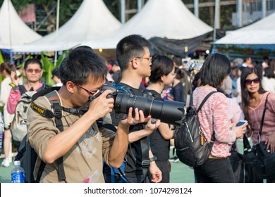 Victoria Park, Hong Kong - 18 Mar, 2018: A professional photographer is taking photos using DSLR in Hong Kong Flower Shoe 2018 held in Victoria Park, Hong Kong.