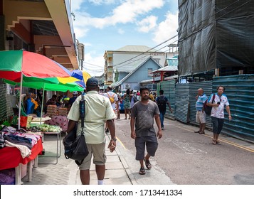 Victoria, Seychelles - January 6, 2020: Creole People And Tourists Walking On The Street At Victoria City.