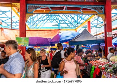 Victoria, Seychelles - January 6, 2020: Crowd Of Creole People And European Tourists At The Sir Selwyn Selwyn-Clarke Market.