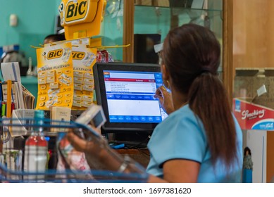 Victoria, Seychelles - January 7, 2020: Creole Woman At The Cashier At The Super Market Of Vicoria, Enters Purchases At The Cash Register.