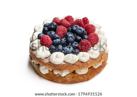 Victoria  sponge cake with whipped cream and berries on top isolated on white 