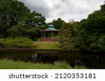 Victorian bandstand surrounded by scenic trees in Sefton Park, Liverpool, UK, said to be the inspiration for The Beatles