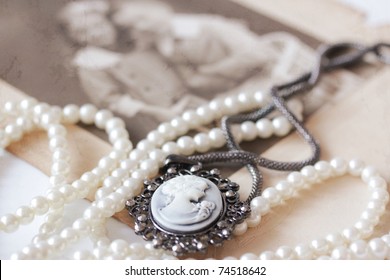 Victorian Cameo And Pearl Necklace In Front Of Vintage Picture