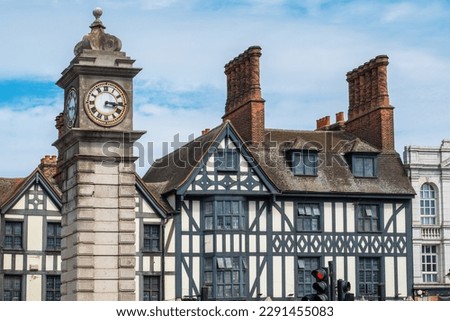 Victorian clock tower next to the half-timbered buildings in Clapham district. London, England