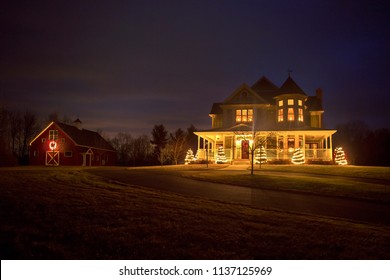 A Victorian House And Barn Decorated For Christmas