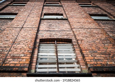 Victorian Old Red Brick Prison Jail With Bars Over Cell Windows Of High Security Run Down Immigration Detention Centre In England Looking Up The Exterior Wall Towards The Sky