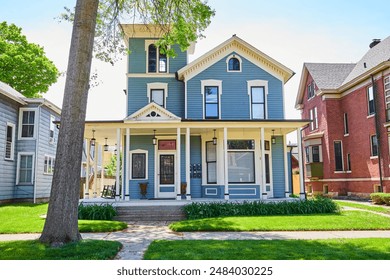 Victorian Style House in Suburban Fort Wayne with Lush Greenery, Daytime View - Powered by Shutterstock