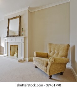 Victorian Style Living Room With A Vintage Armchair And Fireplace