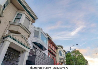 Victorian Style Suburbs Houses In San Francisco, California. Low Angle View Of Houses With Single Gate Doors And Bay Windows With A View Of Street Lamp And Trees On The Right.