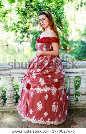 Victorian woman 19th century posing in red dress