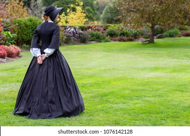 Victorian woman in black dress and bonnet