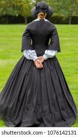 Victorian Woman In Black Dress And Bonnet