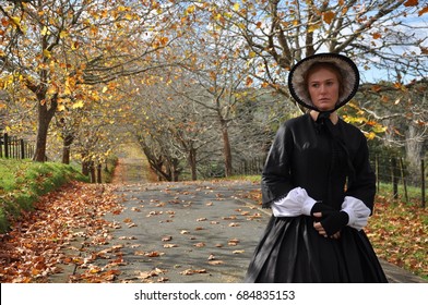 Victorian Woman On Autum Road Wearing Bonnet