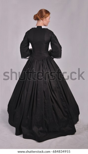 Victorian woman plain background back view looking\
to right side
