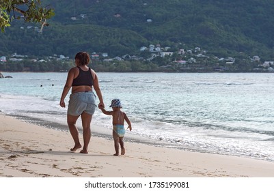 Victoriia, Seychelles - 01.06.2020 - Creole Family Walking At The Beach At Evening