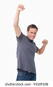 Victorious Young Man Raising Fist Against A White Background