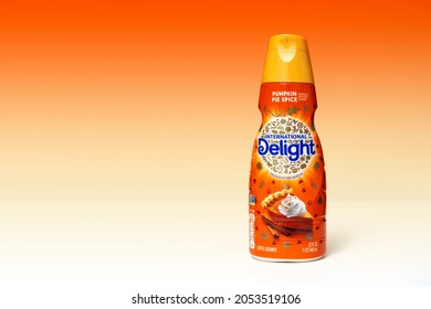 Victorville, CA, USA – October 4, 2021: A Bottle Of Delight International Pumpkin Pie Spice Coffee Creamer With An Orange Background. 