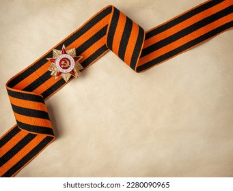 Victory Day 1945. The holiday is May 9. St. George ribbon. A piece of old paper for your text. The inscription on the badge of the Patriotic War. - Shutterstock ID 2280090965