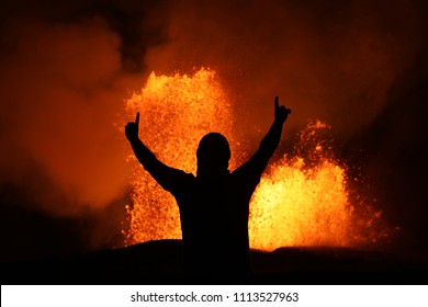 Victory Pose In Front Of A Lava Fountain Of The Volcanic Eruption Of Kilauea In Hawaii