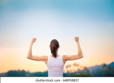 Victory and success! Strong and confident woman flexing. 