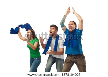 Victory. Three soccer fans woman and men cheering for favourite sport team with bright emotions isolated on white studio background. Looking excited, supporting. Concept of sport, fun, support.