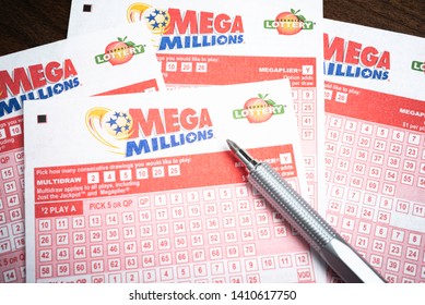 Vidalia, Georgia / USA - May 27, 2019: A Spread Of Unused Or Blank Official Numbers Game Form For Georgia's Mega Million Lottery Ticket Purchase In The State Of Georgia Set With Pen On A Wood Table.