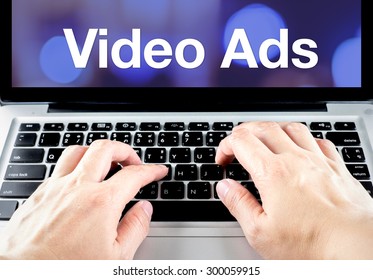 Video Ads Word On Laptop Screen With Hand Type On Keyboard, Digital Advertising Concept.