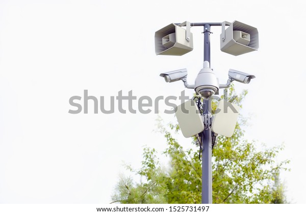 video and audio surveillance\
system on a pole in the city park, big brother is watching\
us