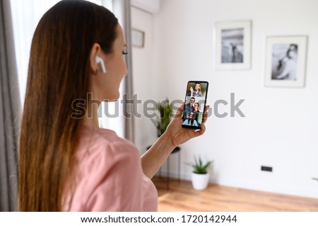 Video call, video chat. A girl is using smartphone for online video communication with friends