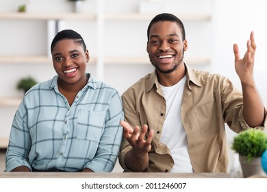 Video Call. Cheerful African American Family Couple Talking And Smiling To Camera Communicating Online Sitting Indoors. Portrait Of Happy Black Spouses. Modern Remote Communication
