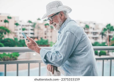 Video call concept. Happy smiling bearded senior man talking on mobile phone using phone webcam to communicate in video chat - Powered by Shutterstock