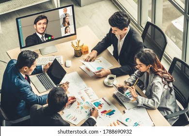 Video call group business people meeting on virtual workplace or remote office. Telework conference call using smart video technology to communicate colleague in professional corporate business. - Shutterstock ID 1788690932