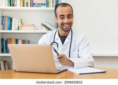 Video Call Of Latin American Doctor With Patient At Computer At Hospital