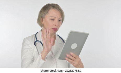 Video Call On Tablet By Old Female Doctor On White Background