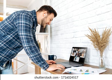 Video Call. Online Business Meeting In Video Conference In The Zoom App. A Young Attractive Guy Communicates With His Colleagues On A Video Call Using A Laptop. Distant Work At Home