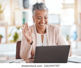 Video call, online and senior business woman waving greeting on internet, website or web conference from her office. Elderly, corporate and professional or executive employee using laptop for meeting - Powered by Shutterstock