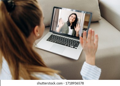 Video call. Two young attractive girls  communicate via video communication in zoom app using a laptop. Online meeting with friend - Shutterstock ID 1718936578