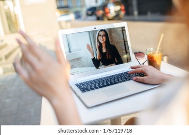 Video call. Webcam shot young woman on the laptop screen, two friends have video chat in summer cafe outdoors - Shutterstock ID 1757119718