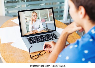 video call. woman and man talking on web camera in office