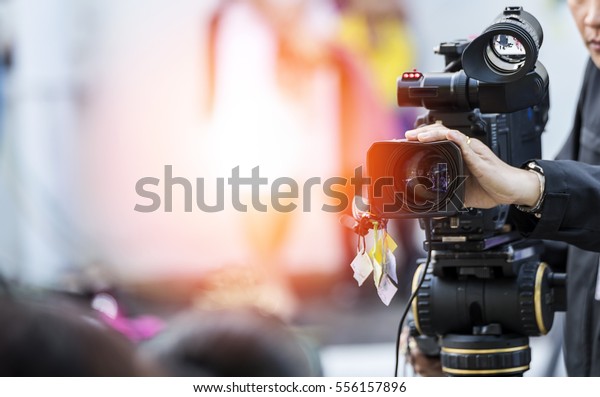 Video camera\
operator working with his\
equipment